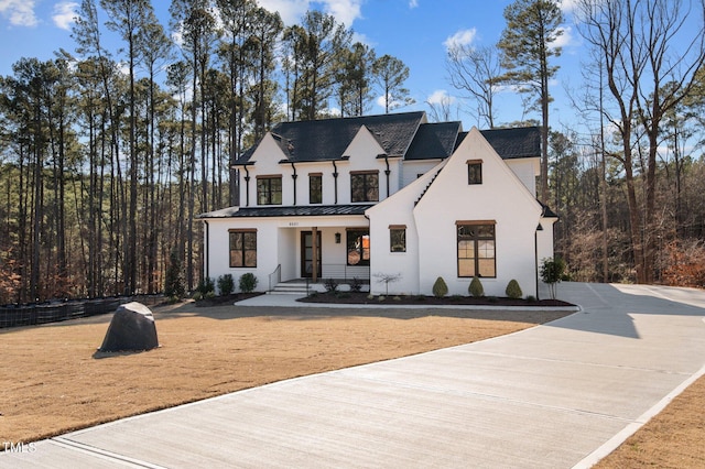 view of front of home with covered porch, metal roof, and a standing seam roof