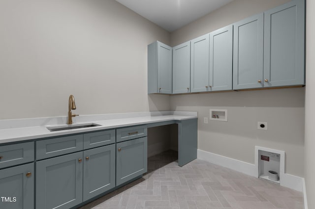 laundry room with hookup for an electric dryer, washer hookup, a sink, baseboards, and cabinet space