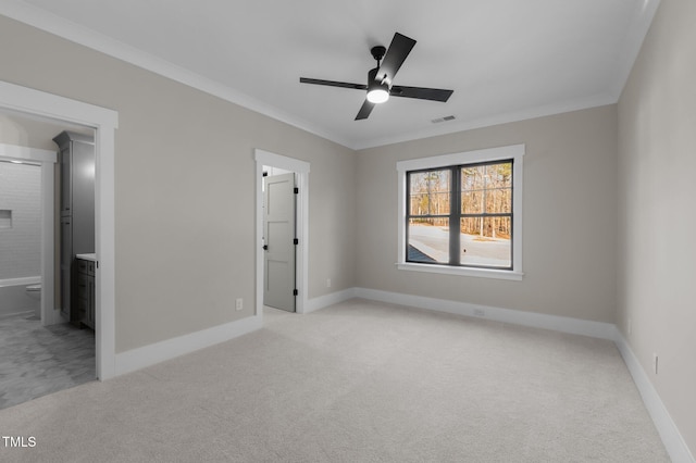 unfurnished bedroom featuring light carpet, crown molding, visible vents, and baseboards