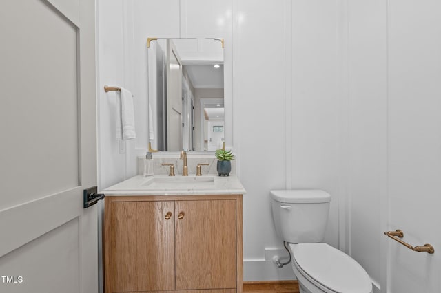 bathroom with toilet and vanity