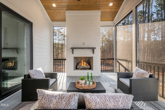 sunroom / solarium with wooden ceiling and a fireplace