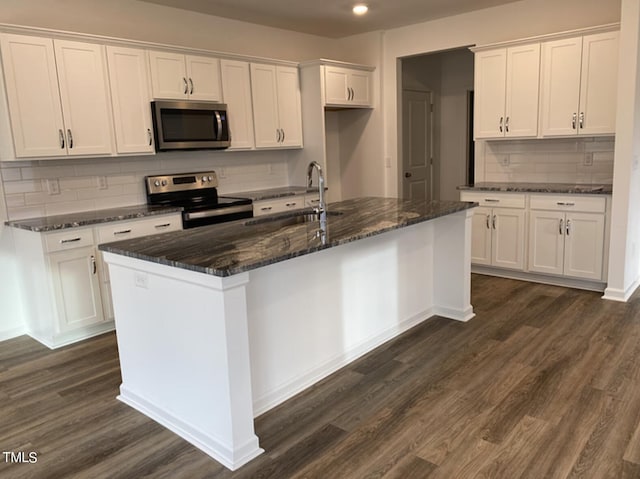 kitchen with white cabinets and appliances with stainless steel finishes