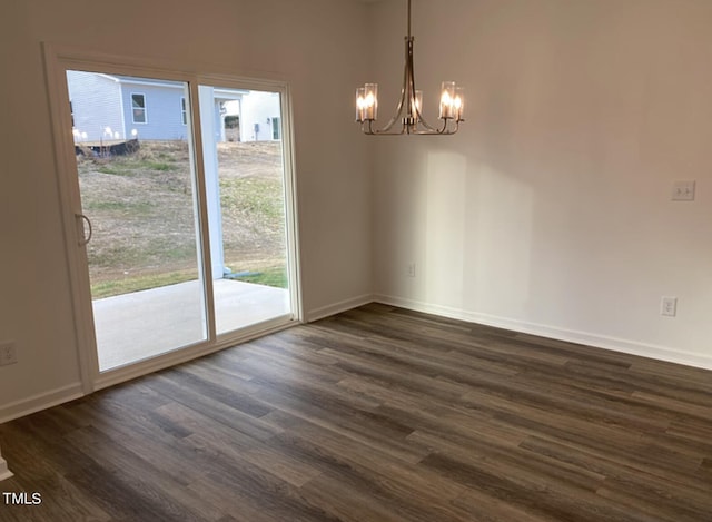 unfurnished dining area with a chandelier and dark hardwood / wood-style floors