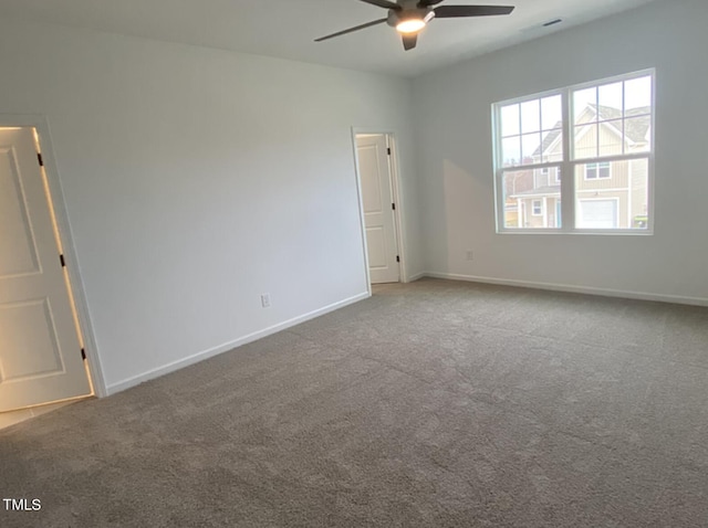 empty room with carpet flooring and ceiling fan