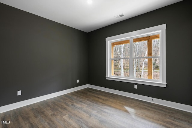 spare room featuring dark wood-type flooring