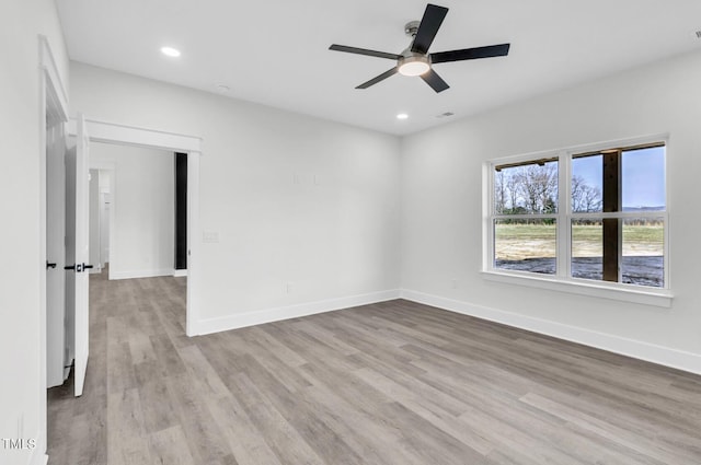 spare room featuring wood-type flooring and ceiling fan