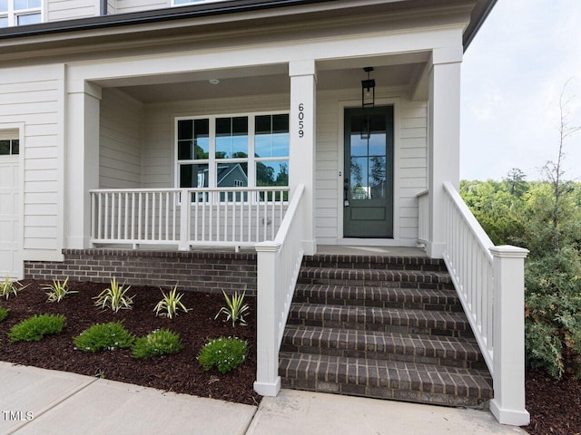 view of exterior entry featuring a porch