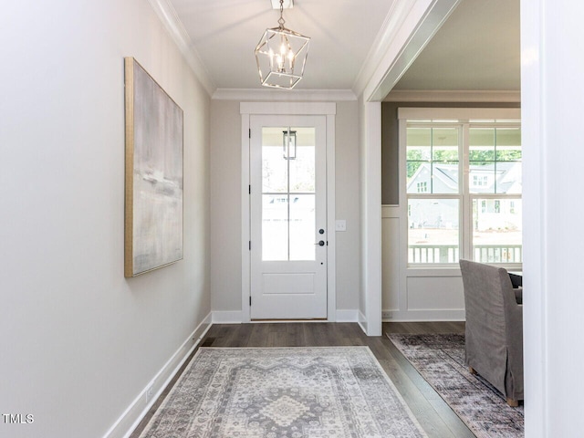 entrance foyer with an inviting chandelier, crown molding, and wood finished floors