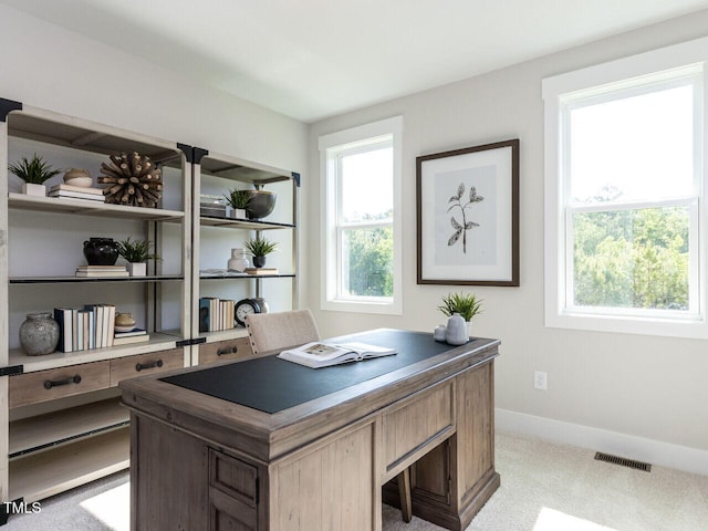 home office with light carpet, baseboards, and visible vents