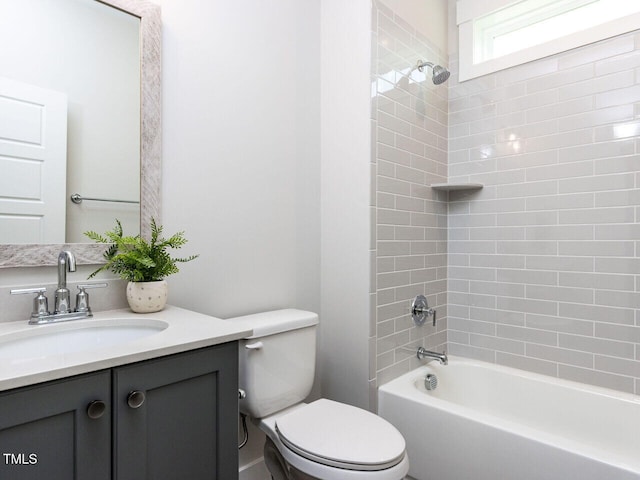 bathroom featuring toilet, vanity, and shower / bathtub combination