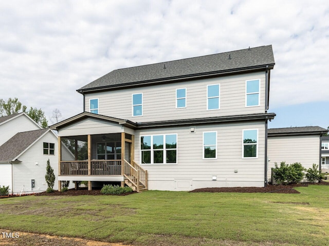 back of house with a sunroom, a yard, and a ceiling fan