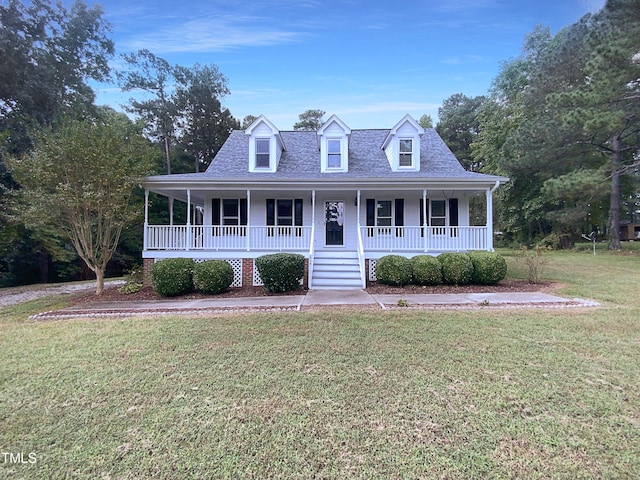 cape cod home featuring a porch and a front lawn