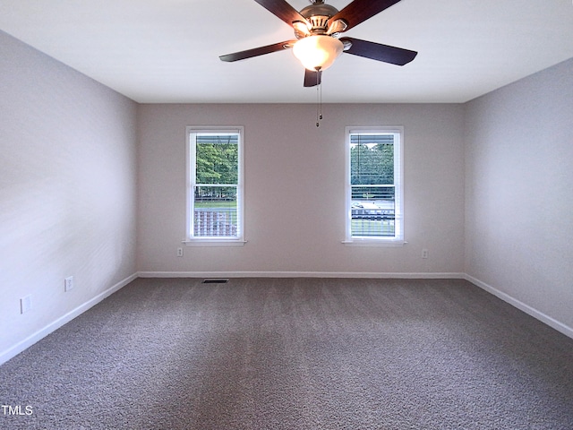 spare room with carpet floors and ceiling fan