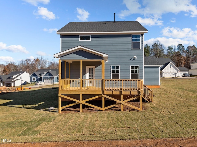 rear view of property featuring a yard and a deck