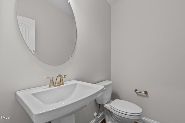 345 Sutherland Dr, Franklinton, NC 27525 - half bathroom with baseboards, a sink, and toilet