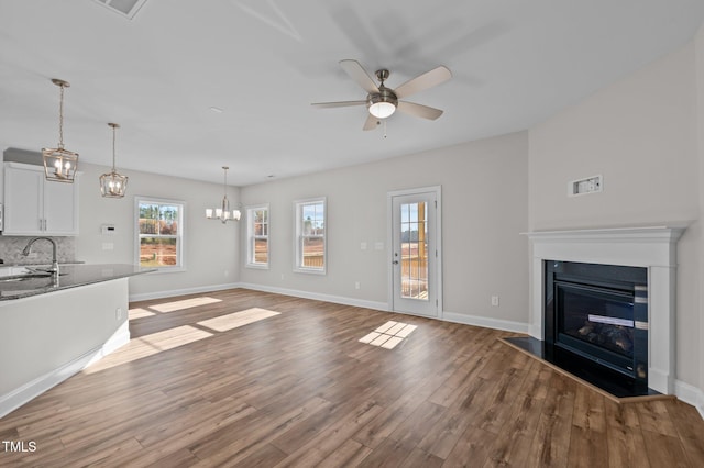 345 Sutherland Dr, Franklinton, NC 27525 - unfurnished living room featuring wood finished floors, a ceiling fan, and baseboards