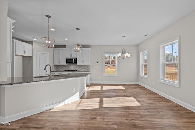 345 Sutherland Dr, Franklinton, NC 27525 - kitchen featuring stainless steel microwave, a sink, a chandelier, healthy amount of natural light, and recessed lighting