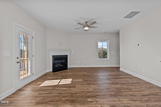 345 Sutherland Dr, Franklinton, NC 27525 - unfurnished living room featuring a fireplace with flush hearth, a ceiling fan, wood finished floors, and baseboards