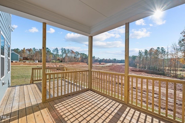 wooden deck with a rural view