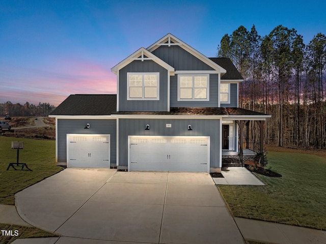 view of front of property featuring a yard and a garage