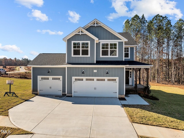 craftsman house featuring a front yard and a garage