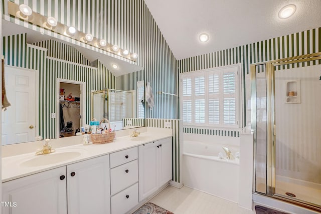 bathroom featuring tile flooring, shower with separate bathtub, vanity with extensive cabinet space, double sink, and vaulted ceiling