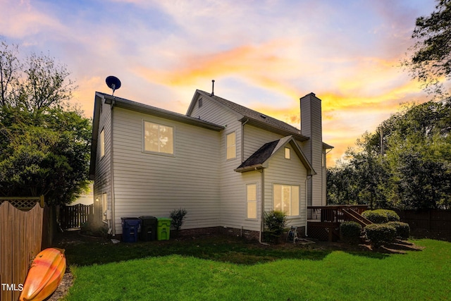 property exterior at dusk featuring a yard