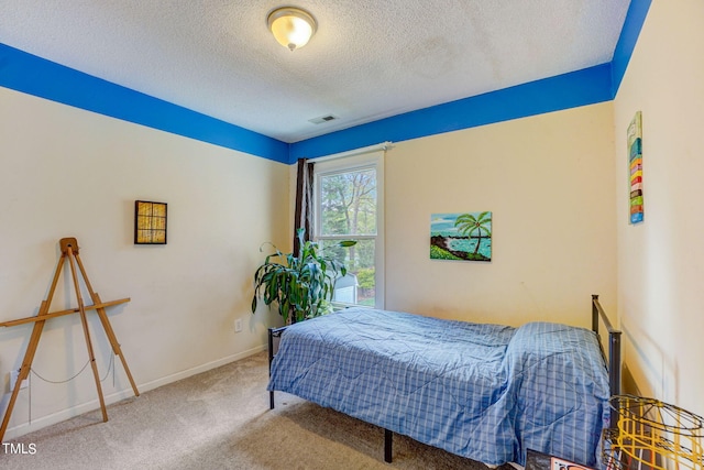 carpeted bedroom with a textured ceiling