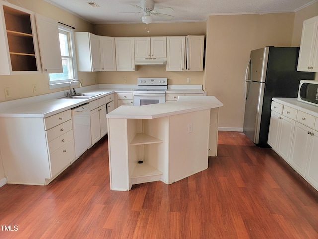 kitchen with ceiling fan, hardwood / wood-style floors, white appliances, a center island, and white cabinets