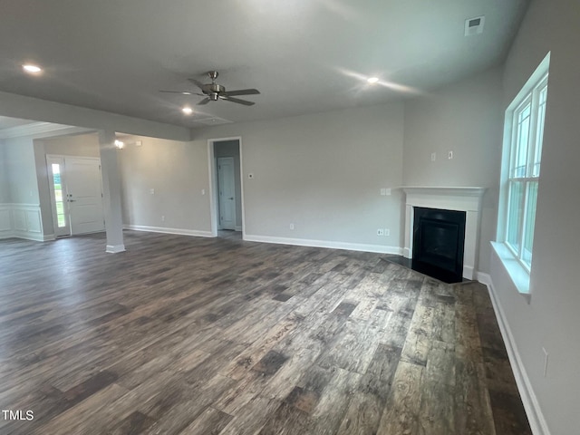 unfurnished living room with ceiling fan and dark hardwood / wood-style flooring