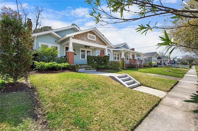 view of front of home featuring a front yard and covered porch