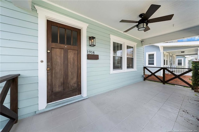 entrance to property with covered porch and ceiling fan