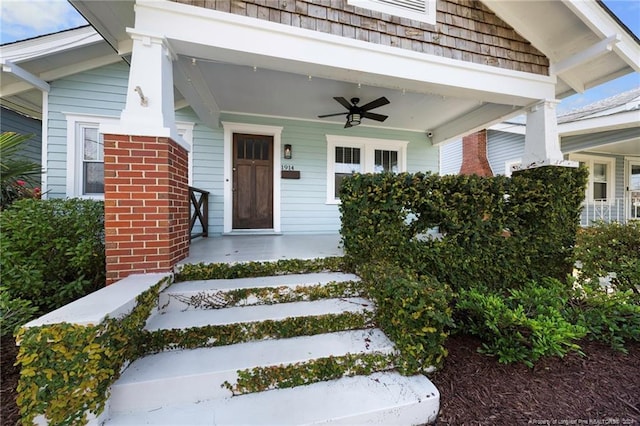 entrance to property with ceiling fan and a porch