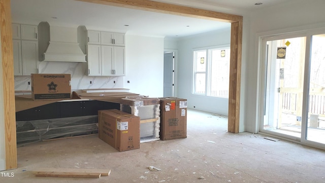 kitchen featuring white cabinets and custom exhaust hood