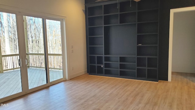 empty room featuring baseboards and wood finished floors