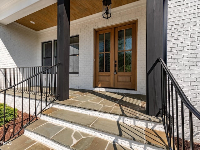 122 W Beech Slope Ct, Chapel Hill, NC 27517 - view of exterior entry featuring covered porch, brick siding, and french doors