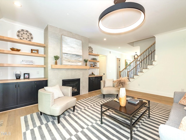 122 W Beech Slope Ct, Chapel Hill, NC 27517 - living room featuring recessed lighting, stairway, a tiled fireplace, and light wood finished floors
