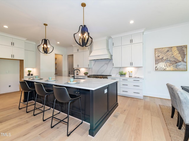 122 W Beech Slope Ct, Chapel Hill, NC 27517 - kitchen featuring an inviting chandelier, custom exhaust hood, light wood-type flooring, and white cabinetry