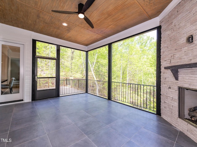 122 W Beech Slope Ct, Chapel Hill, NC 27517 - unfurnished sunroom featuring a stone fireplace, ceiling fan, and a wealth of natural light