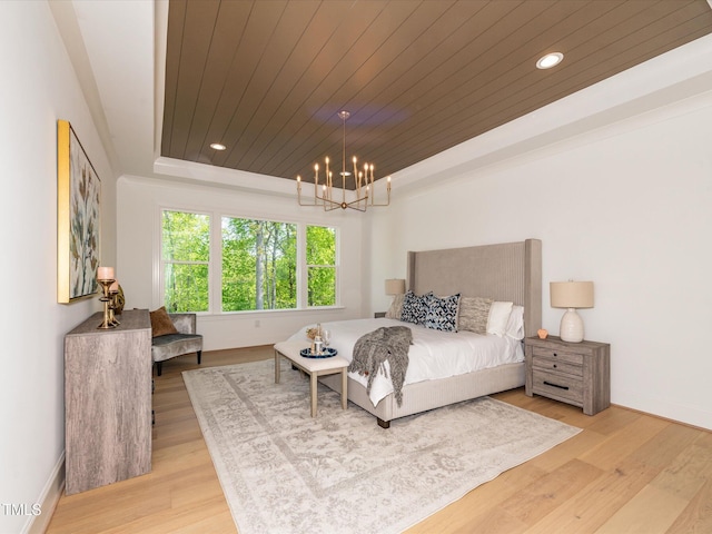 122 W Beech Slope Ct, Chapel Hill, NC 27517 - bedroom featuring an inviting chandelier, baseboards, wooden ceiling, wood finished floors, and a tray ceiling