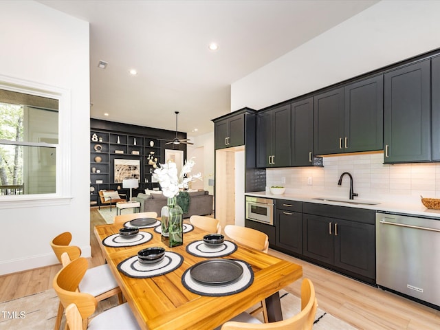 122 W Beech Slope Ct, Chapel Hill, NC 27517 - kitchen with a sink, light wood finished floors, light countertops, decorative backsplash, and stainless steel dishwasher