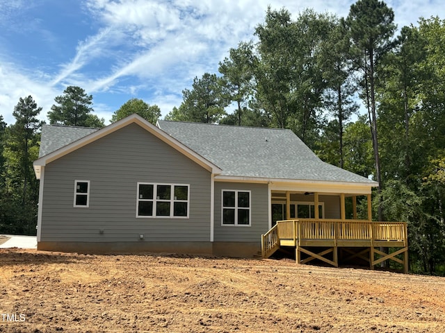 rear view of house featuring a wooden deck