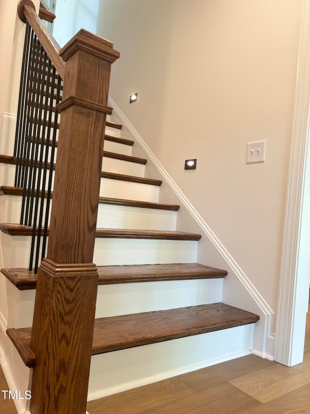 staircase featuring hardwood / wood-style flooring