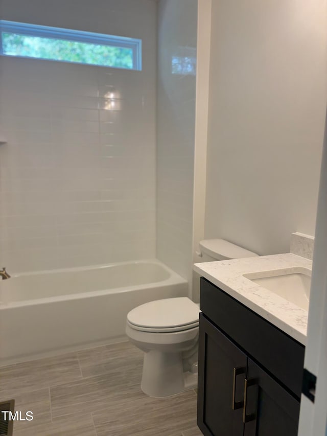 full bathroom featuring bathtub / shower combination, vanity, and toilet