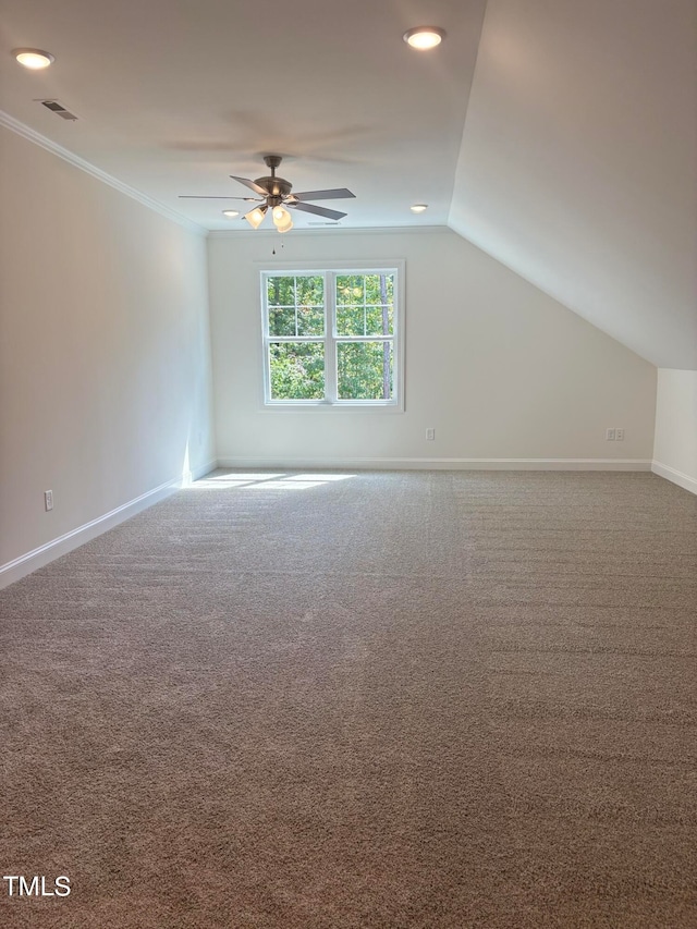 additional living space featuring carpet, lofted ceiling, and ceiling fan