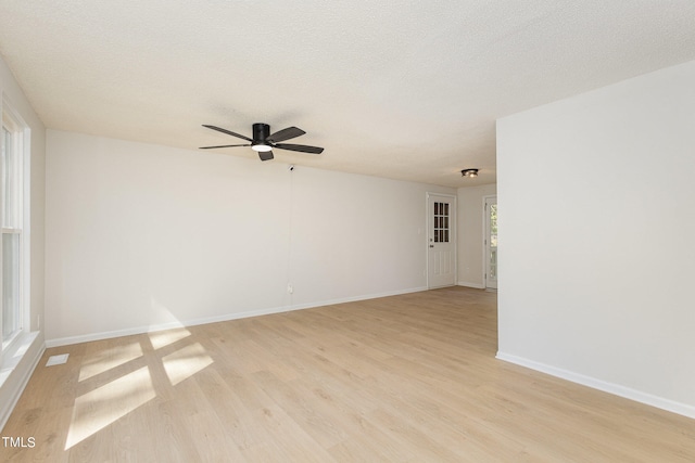 unfurnished room with light hardwood / wood-style floors, a textured ceiling, and ceiling fan