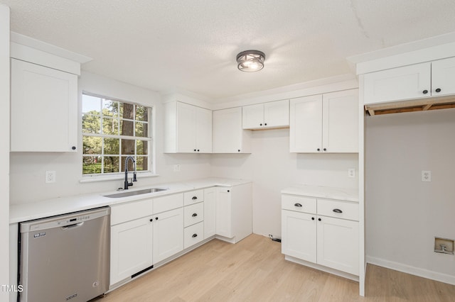 kitchen with light hardwood / wood-style floors, dishwasher, white cabinets, and sink