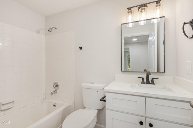 full bathroom featuring vanity, toilet, a textured ceiling, and tiled shower / bath