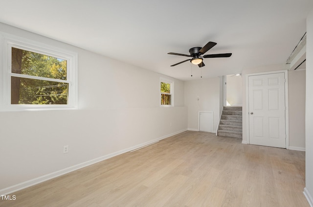 unfurnished bedroom featuring ceiling fan, multiple windows, and light hardwood / wood-style floors