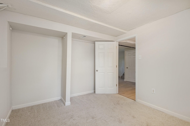 unfurnished bedroom with carpet and a textured ceiling